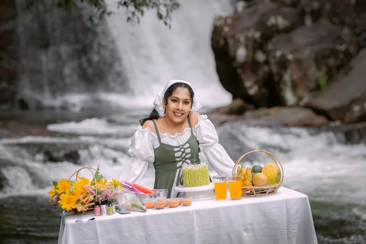 Woman at a celebration table beside a waterfall